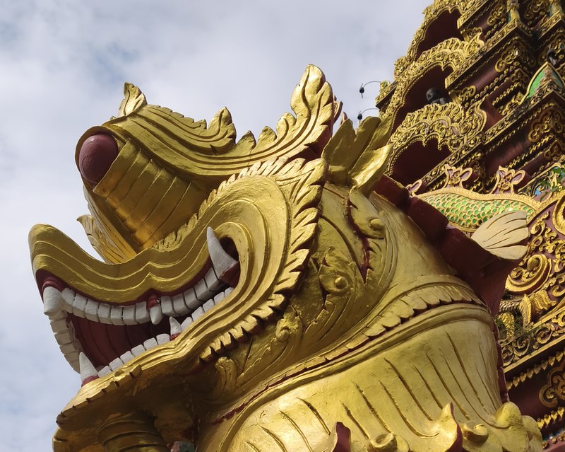 Ornate golden naga decoration on a Chiang Mai temple roof